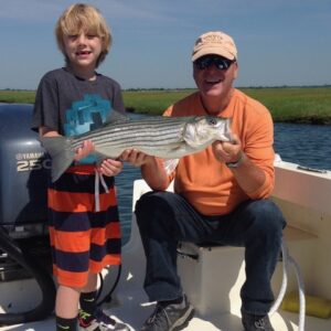A young boy caught his first striped bass