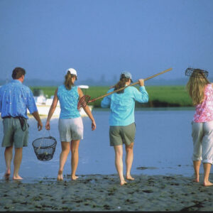 photo of one man and 3 women going clamming